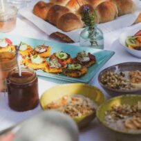 Freshly baked bread rolls and colourful healthy snacks on a table. Fresh bread rolls and healthy snacks for a nutritious meal.