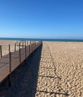 Beach walkway leading to the sea, perfect for outdoor fitness and relaxation.